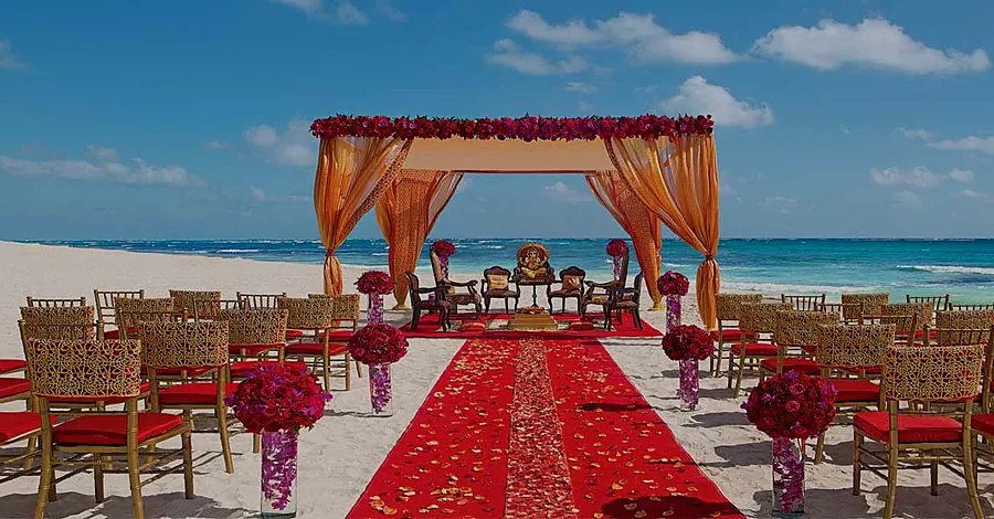 Alila Diwa Goa beach wedding mandap with red and gold decor on Gonsua Beach