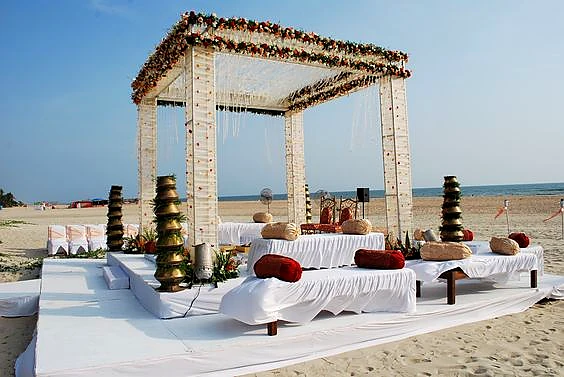Alila Diwa Goa white beach mandap setup with Arabian Sea ocean view at sunset