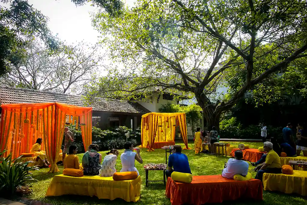 Alila Diwa Goa haldi ceremony garden setup with yellow and orange floral decorations