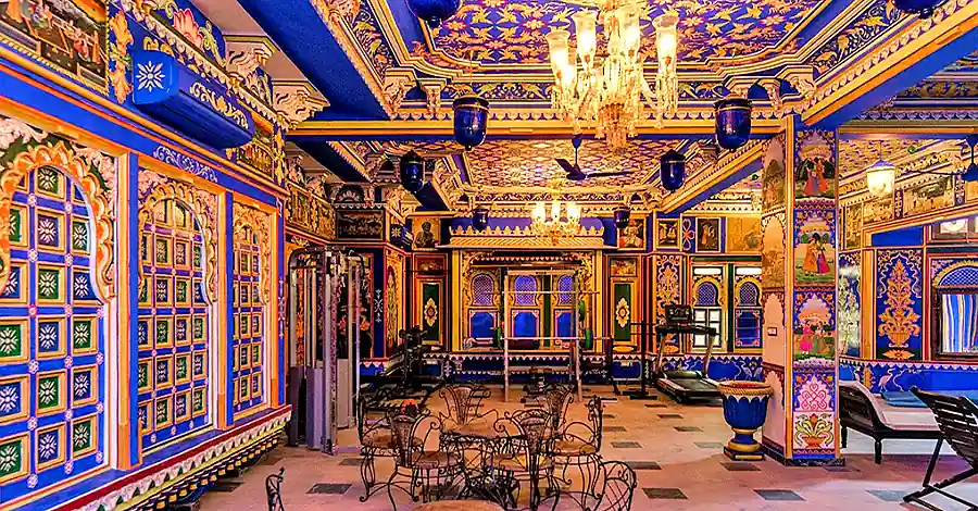 Chunda Palace Udaipur ornate blue and gold lobby interior with traditional Rajasthani decor