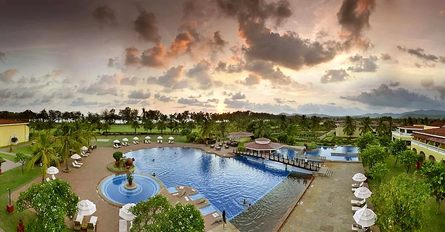 The Lalit Golf & Spa Resort Goa - Aerial View of Pool and Property at Sunset